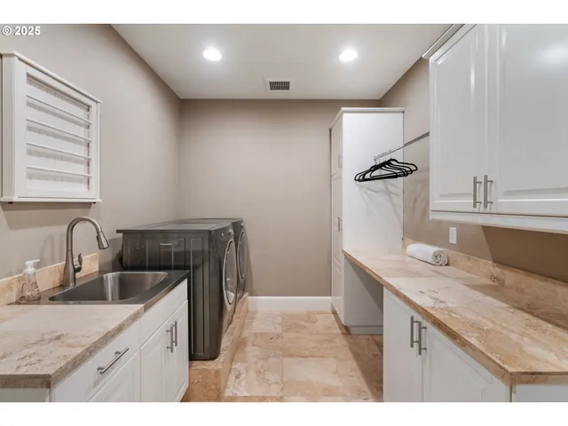 a kitchen with a sink appliances and cabinets