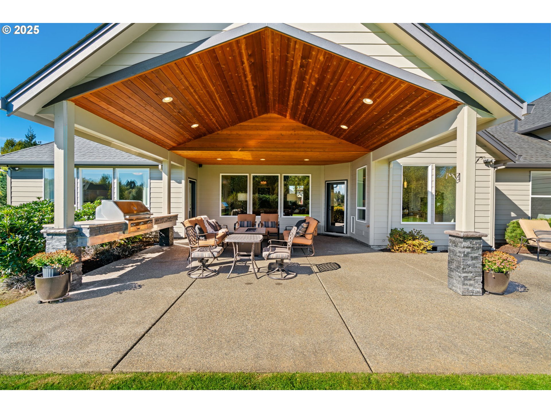 1613 Southwest 25th Circle Battle Ground, WA 98604 - Photo 31 of 48 a view of a patio with table and chairs under an umbrella