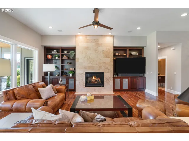 a living room with furniture a fireplace and a flat screen tv