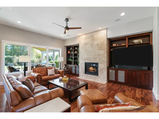 a living room with furniture a flat screen tv and a fireplace
