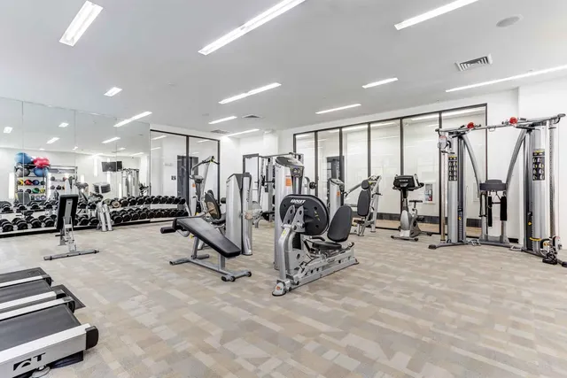 a kitchen with granite countertop kitchen island stainless steel appliances a sink stove and wooden floor