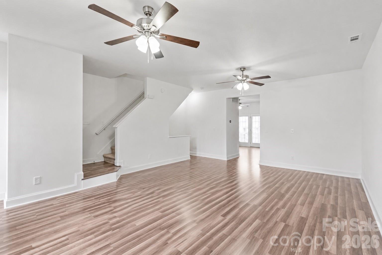 1707 Kashmir White Lane Fort Mill, SC 29708 - Photo 17 of 33 a view of an empty room with wooden floor and a ceiling fan
