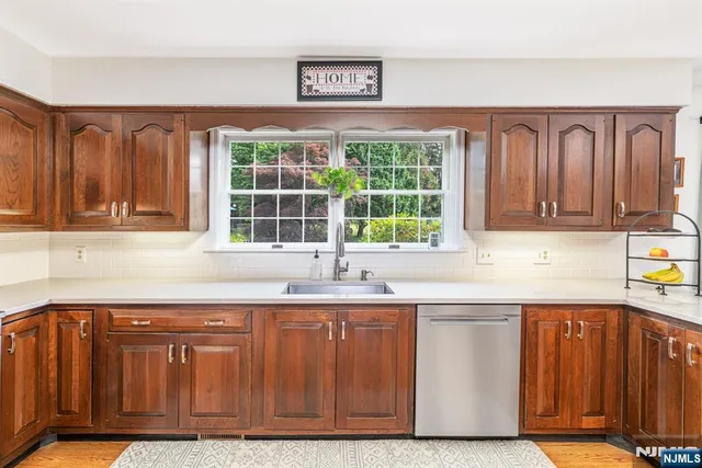 a kitchen with stainless steel appliances granite countertop a sink and a cabinets