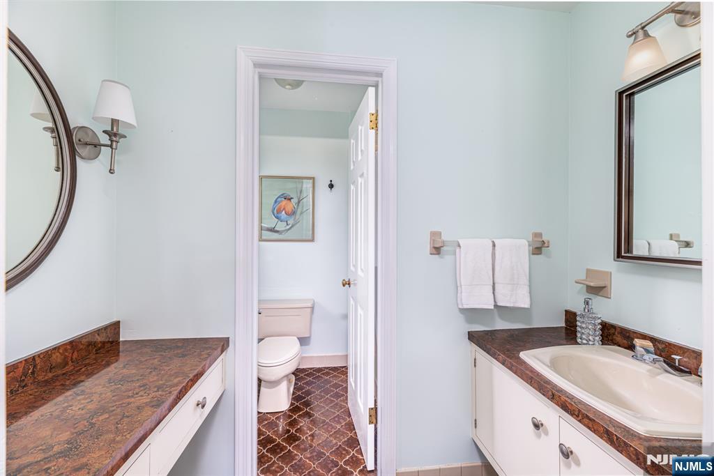 208 Willows Road Newton, NJ 07860 - Photo 22 of 44 a bathroom with a sink a toilet and a mirror