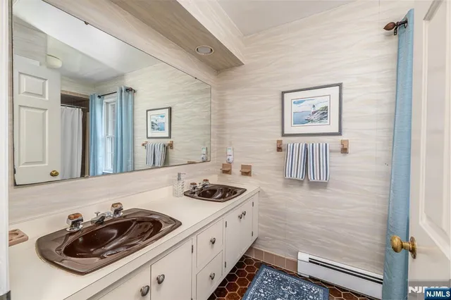 a bathroom with a sink a mirror and cabinets