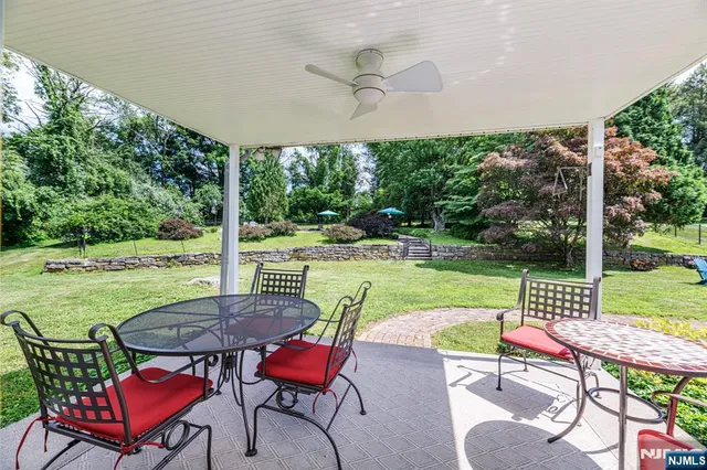 a view of a patio with a table chairs and a backyard