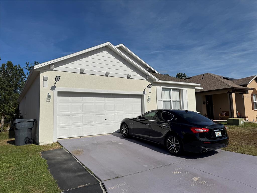 1511 Pine Ridge Drive Davenport, FL 33896 - Photo 1 of 1 a car parked in front of a house