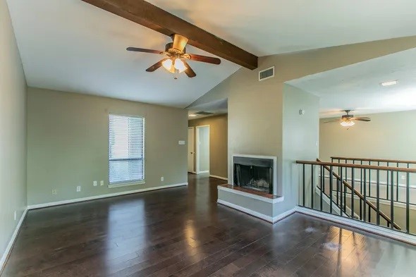 2804 Stewart Drive, Unit 2906 Waco, TX 76708 - Photo 7 of 17 a view of an empty room with wooden floor fireplace and a window