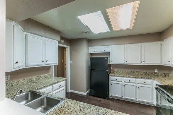 2804 Stewart Drive, Unit 2906 Waco, TX 76708 - Photo 9 of 17 a kitchen with granite countertop a sink stainless steel appliances and cabinets