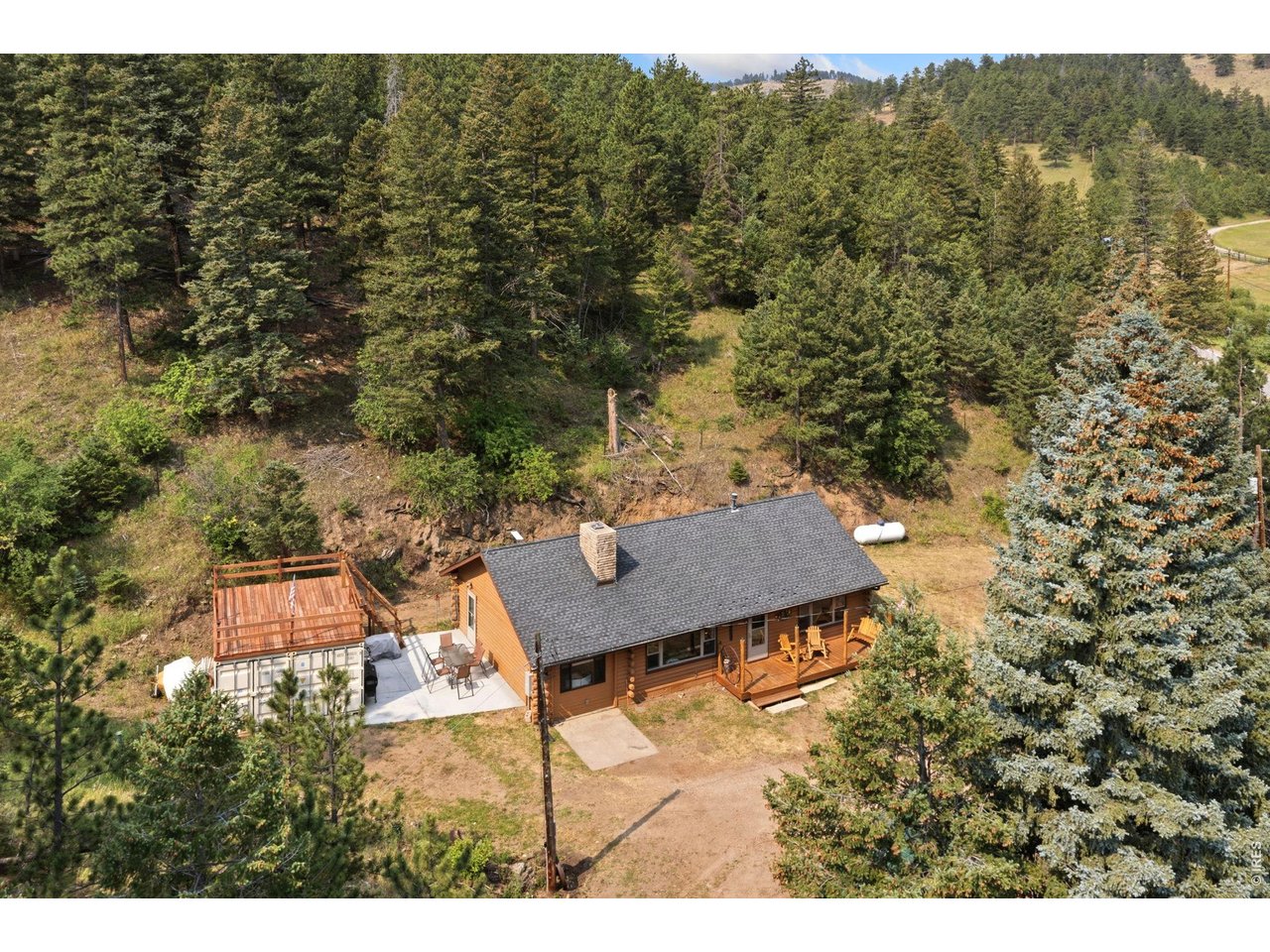 12743 Rist Canyon Road Bellvue, CO 80512 - Photo 2 of 49 a view of a terrace with a table and chairs