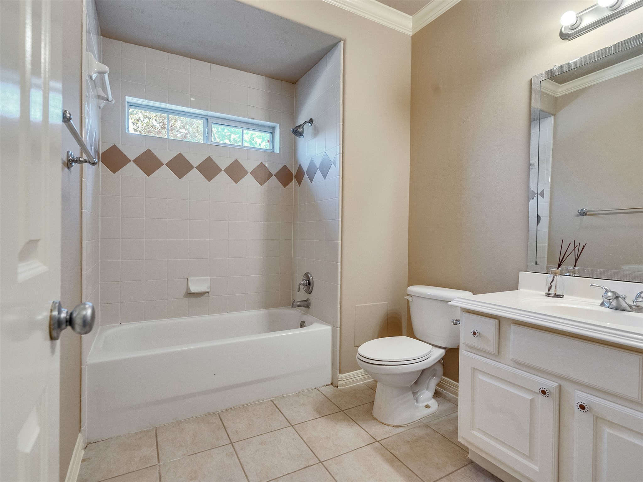 1502 Olive Place Houston, TX 77077 - Photo 19 of 27 Upstairs guest bath with tiled tub/shower combo, vanity, and natural light—clean and functional design.