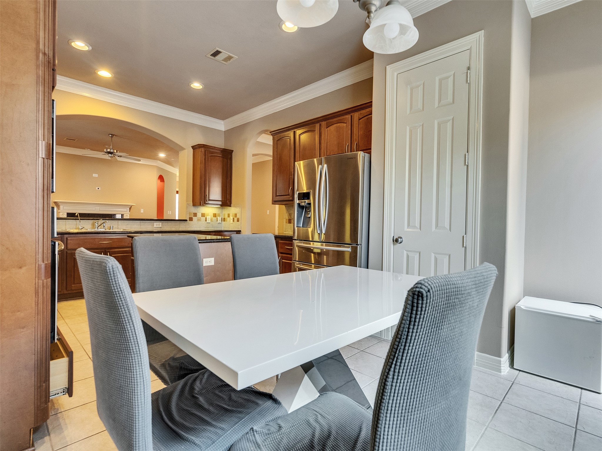 1502 Olive Place Houston, TX 77077 - Photo 10 of 27 Bright breakfast nook with modern dining set and view into a well-appointed kitchen—refrigerator and Breakfast set included