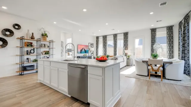 a kitchen with stainless steel appliances granite countertop a stove a refrigerator and a sink