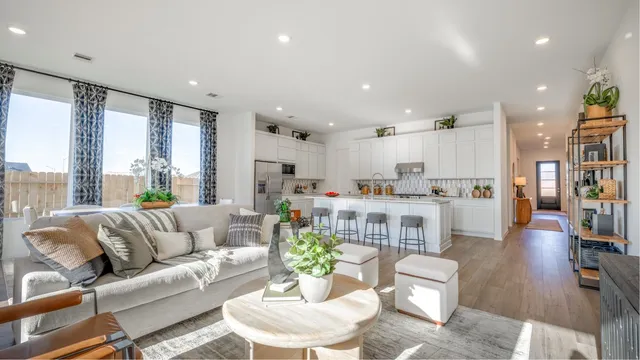 a living room with furniture and large windows