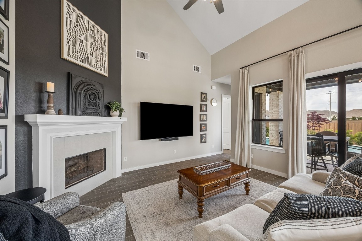 438 Livermore Street Webster, TX 77598 - Photo 11 of 34 a living room with furniture a flat screen tv and a fireplace