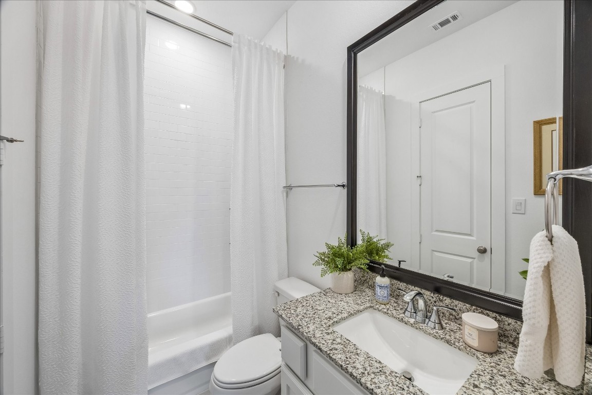 438 Livermore Street Webster, TX 77598 - Photo 16 of 34 a bathroom with a granite countertop sink and a mirror