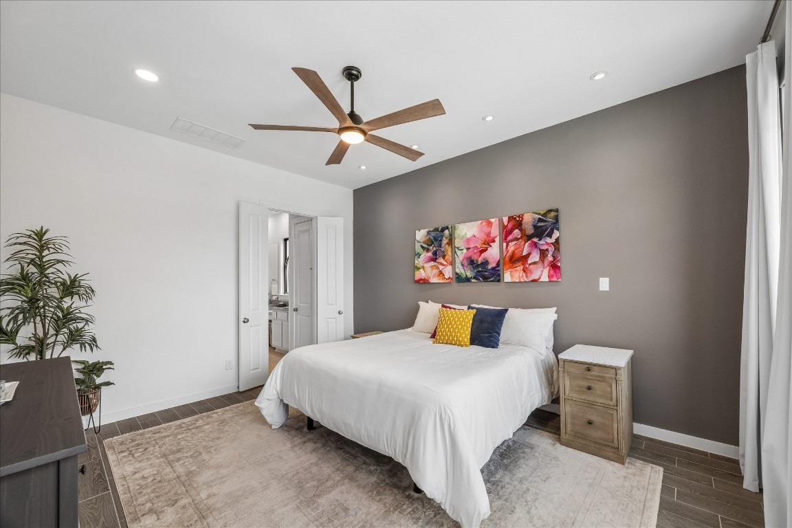 438 Livermore Street Webster, TX 77598 - Photo 18 of 34 a bedroom with a bed and a painting on the wall