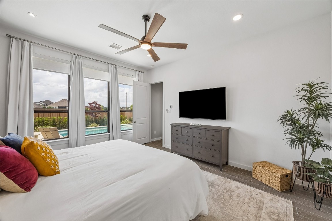 438 Livermore Street Webster, TX 77598 - Photo 19 of 34 a bedroom with a bed and a flat screen tv
