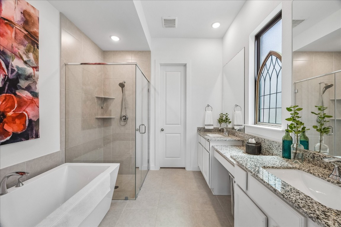 438 Livermore Street Webster, TX 77598 - Photo 20 of 34 a bathroom with a granite countertop tub sink and mirror