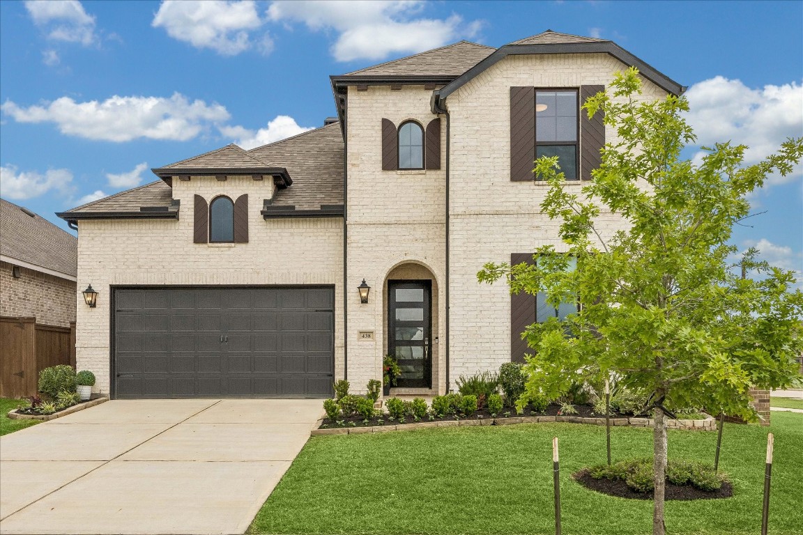 438 Livermore Street Webster, TX 77598 - Photo 2 of 34 a front view of a house with a garden