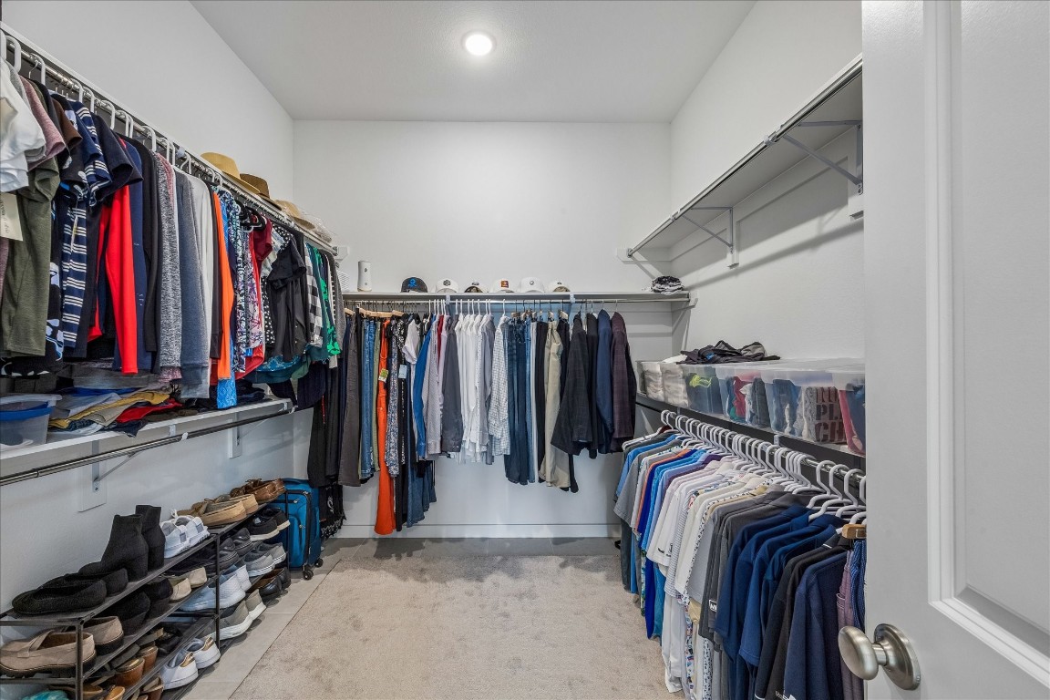 438 Livermore Street Webster, TX 77598 - Photo 21 of 34 a view of walk in closet with clothes and shoes