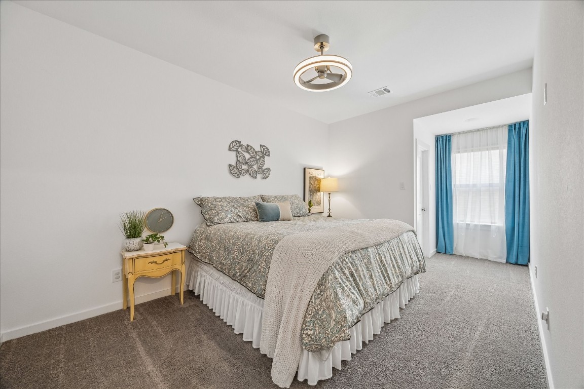 438 Livermore Street Webster, TX 77598 - Photo 24 of 34 a bedroom with a bed and a lamp