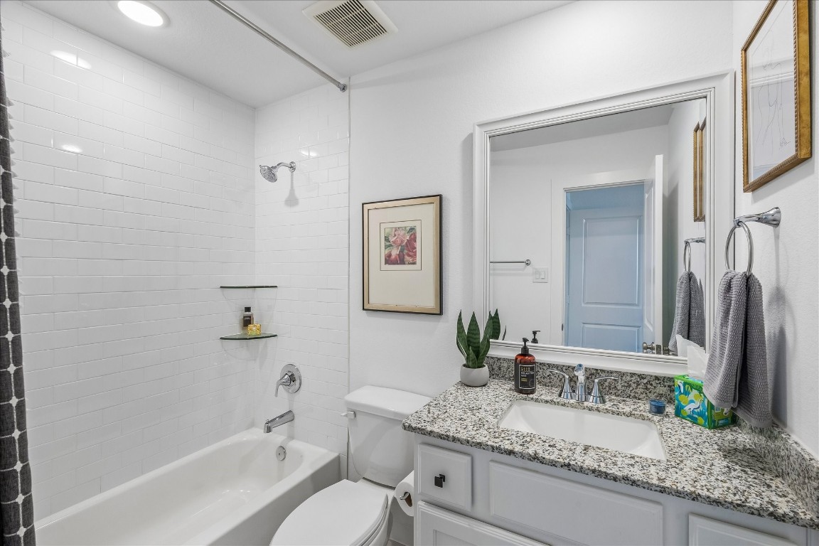438 Livermore Street Webster, TX 77598 - Photo 27 of 34 a bathroom with a granite countertop sink mirror and a bathtub