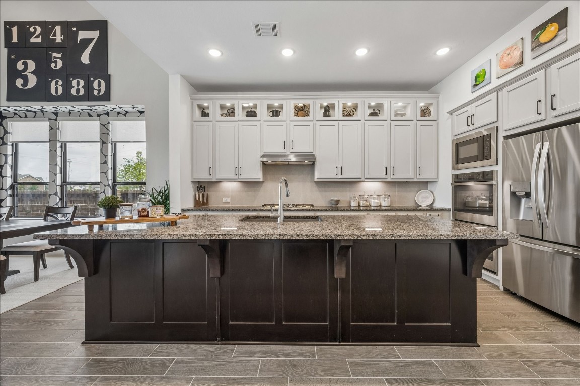 438 Livermore Street Webster, TX 77598 - Photo 8 of 34 a kitchen with stainless steel appliances granite countertop a sink counter space and cabinets