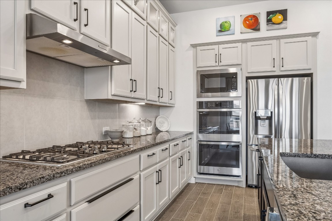 438 Livermore Street Webster, TX 77598 - Photo 9 of 34 a kitchen with stainless steel appliances granite countertop a stove and a refrigerator