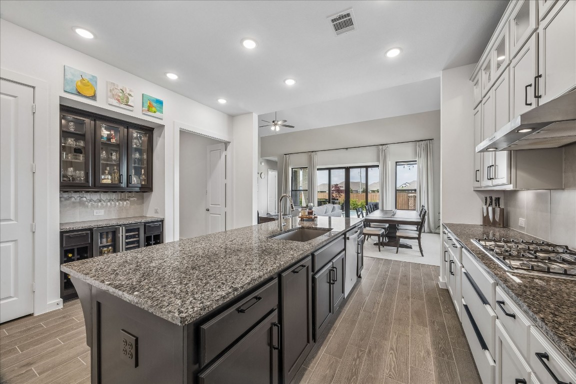 438 Livermore Street Webster, TX 77598 - Photo 10 of 34 a kitchen with stainless steel appliances granite countertop a stove oven a sink dishwasher and cabinets with wooden floor