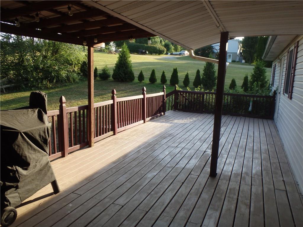 109 Youkers Road Butler, PA 16001 - Photo 23 of 30 a view of a deck with wooden floor a yard tables and chairs