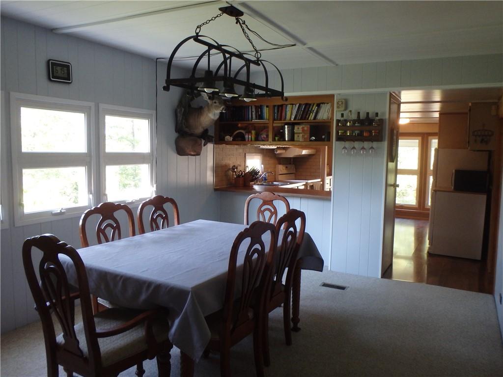 109 Youkers Road Butler, PA 16001 - Photo 8 of 30 a view of a dining room and livingroom with furniture wooden floor a chandelier