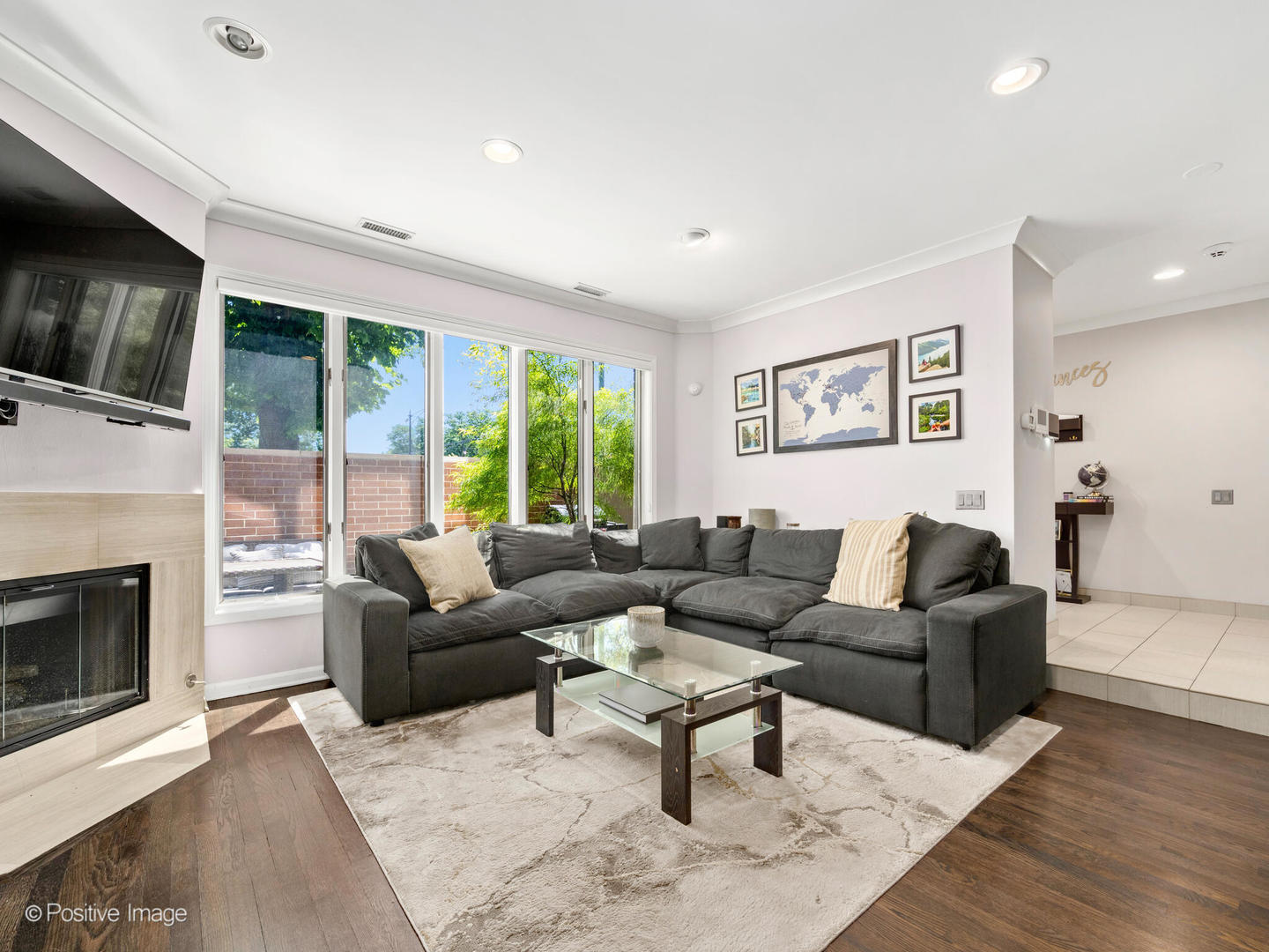 1720 North LaSalle Drive, Unit 1 Chicago, IL 60614 - Photo 2 of 28 a living room with furniture a large window and a fireplace