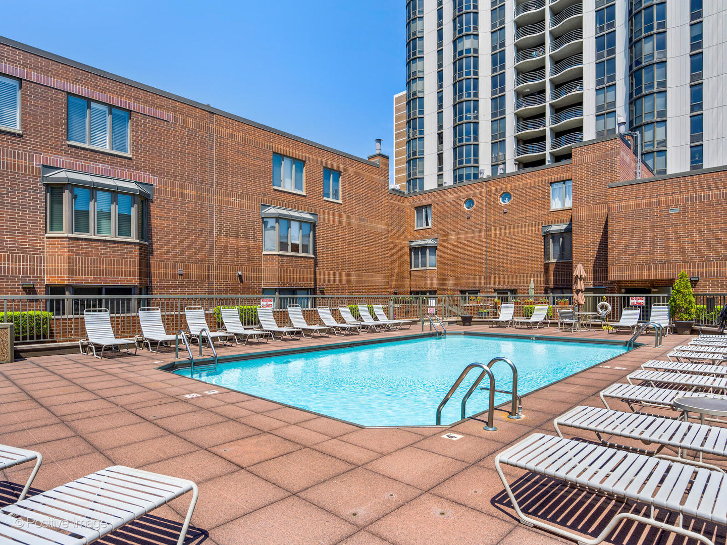 1720 North LaSalle Drive, Unit 1 Chicago, IL 60614 - Photo 24 of 28 a view of a swimming pool with a lounge chairs