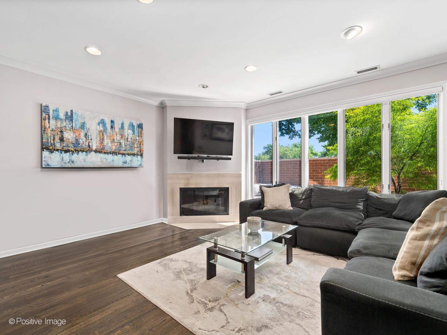 1720 North LaSalle Drive, Unit 1 Chicago, IL 60614 - Photo 4 of 28 a living room with furniture a flat screen tv and a fireplace