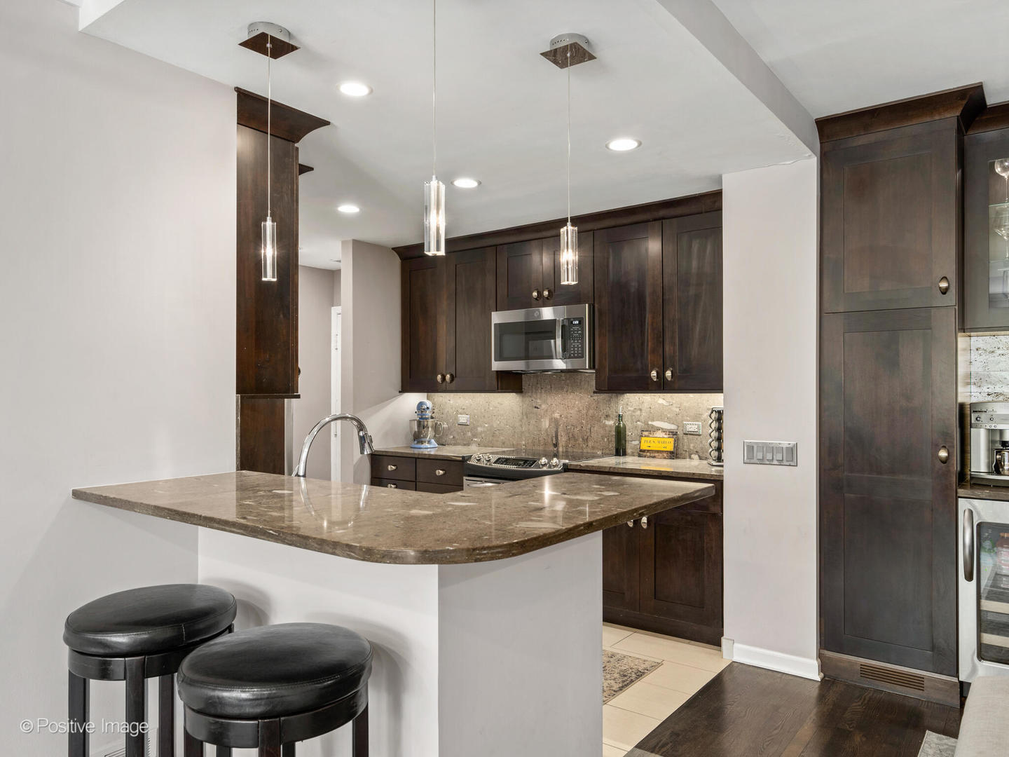 1720 North LaSalle Drive, Unit 1 Chicago, IL 60614 - Photo 8 of 28 a kitchen with stainless steel appliances granite countertop a sink and a refrigerator