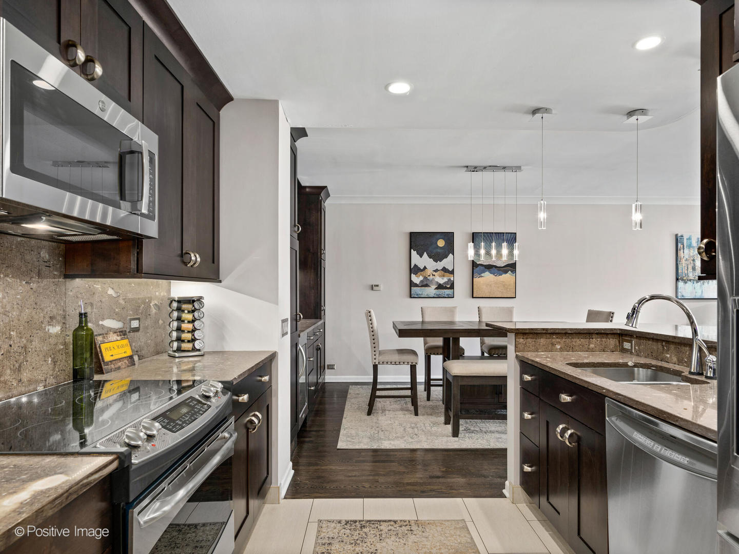 1720 North LaSalle Drive, Unit 1 Chicago, IL 60614 - Photo 9 of 28 a kitchen with a stove a sink and a microwave
