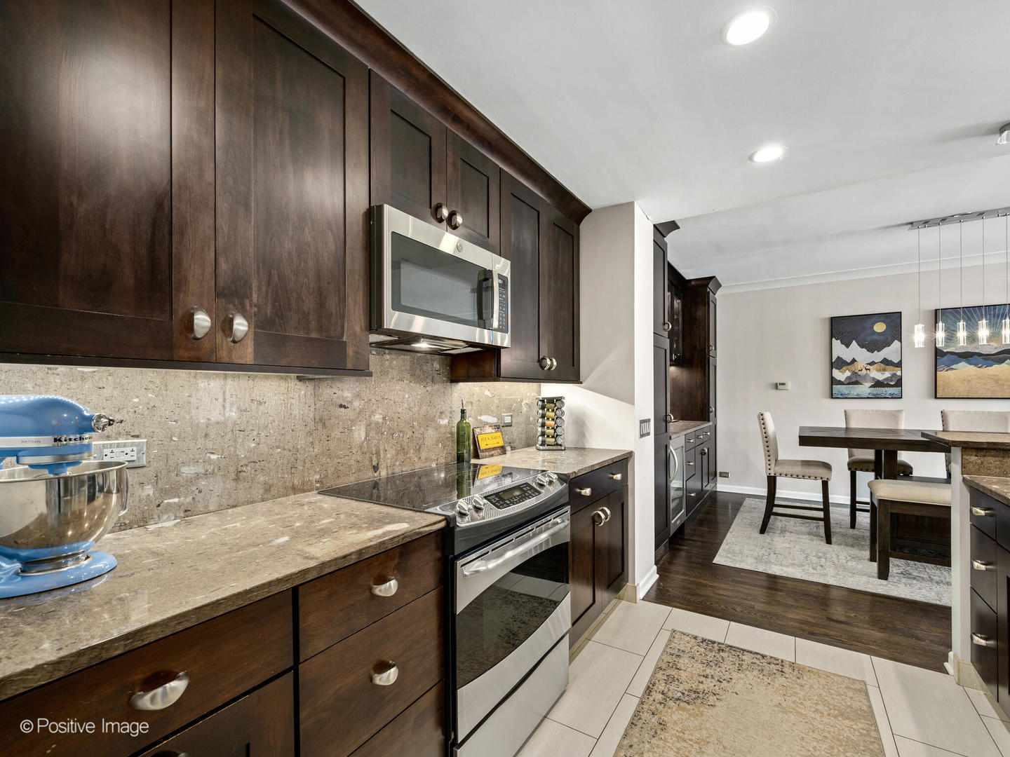 1720 North LaSalle Drive, Unit 1 Chicago, IL 60614 - Photo 10 of 28 a kitchen with granite countertop cabinets stainless steel appliances and wooden floor