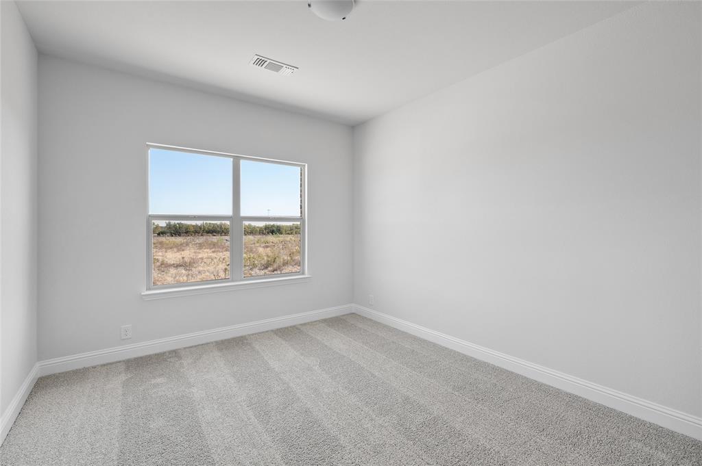 613 Brazos Drive Van Alstyne, TX 75495 - Photo 26 of 29 Carpeted empty room featuring baseboards