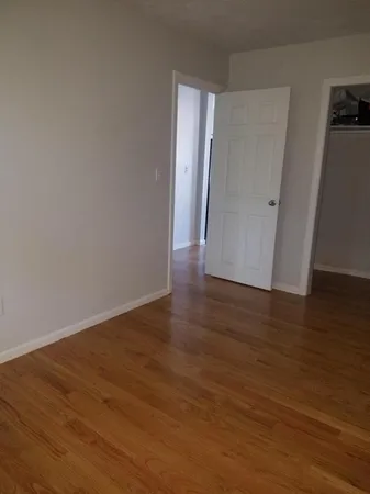 a view of a room with wooden floor and stairs