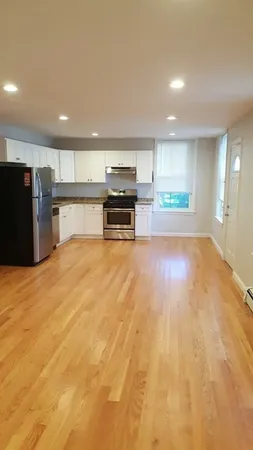 a kitchen with stainless steel appliances a refrigerator and a stove top oven