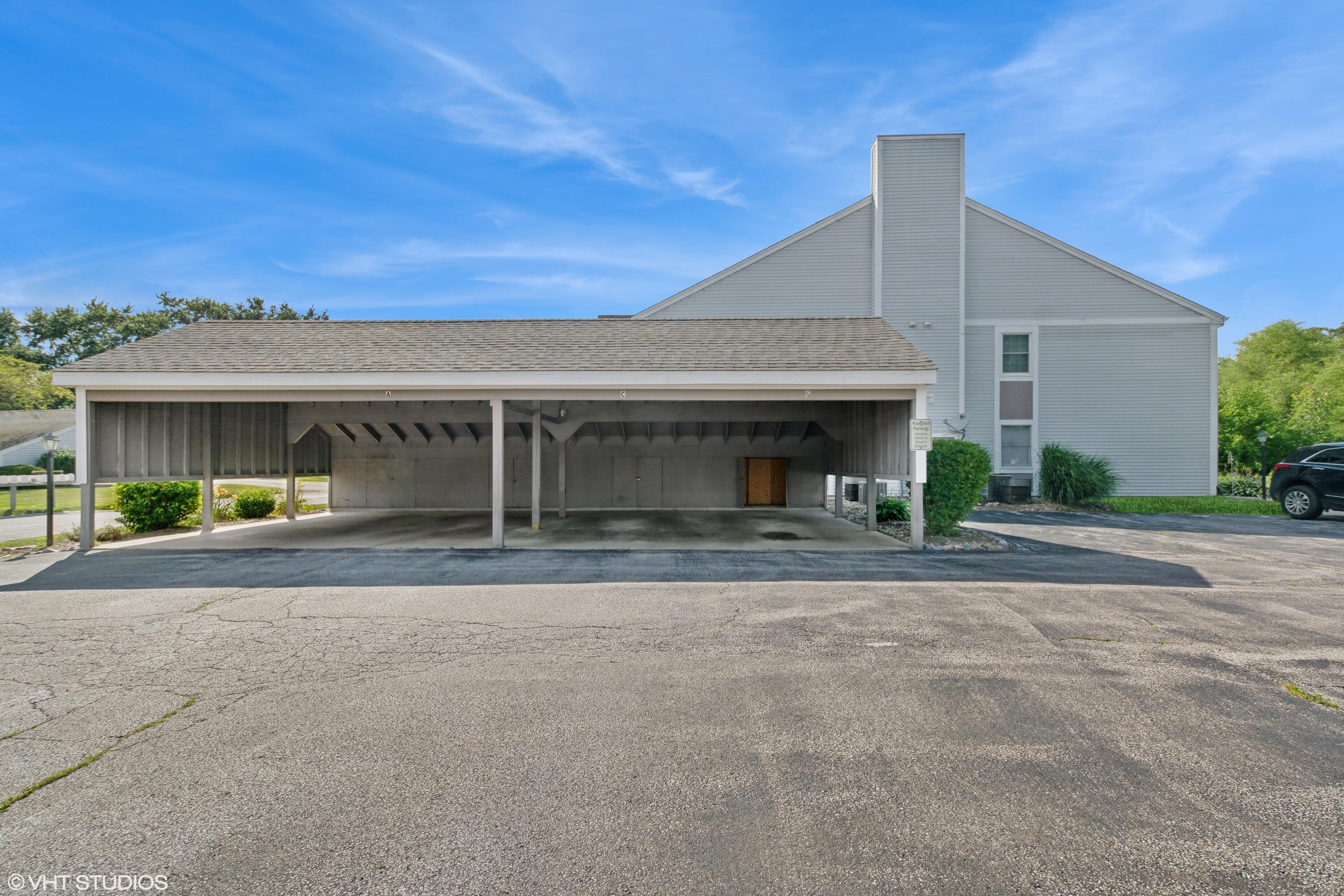 1069 Millpond Road, Unit G Valparaiso, IN 46385 - Photo 12 of 13 a front view of a house with a yard and garage