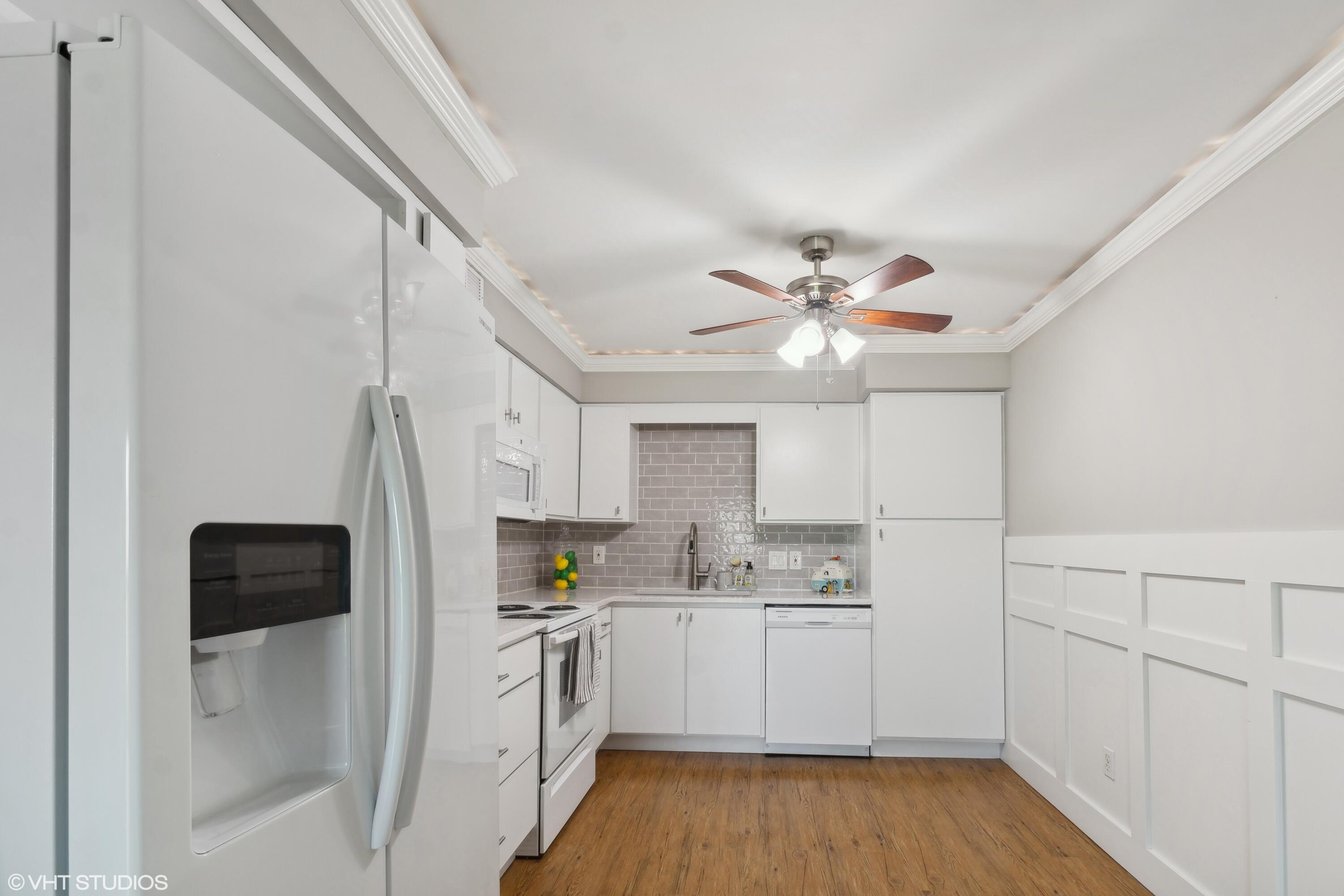 1069 Millpond Road, Unit G Valparaiso, IN 46385 - Photo 3 of 13 a kitchen with white cabinets and white appliances