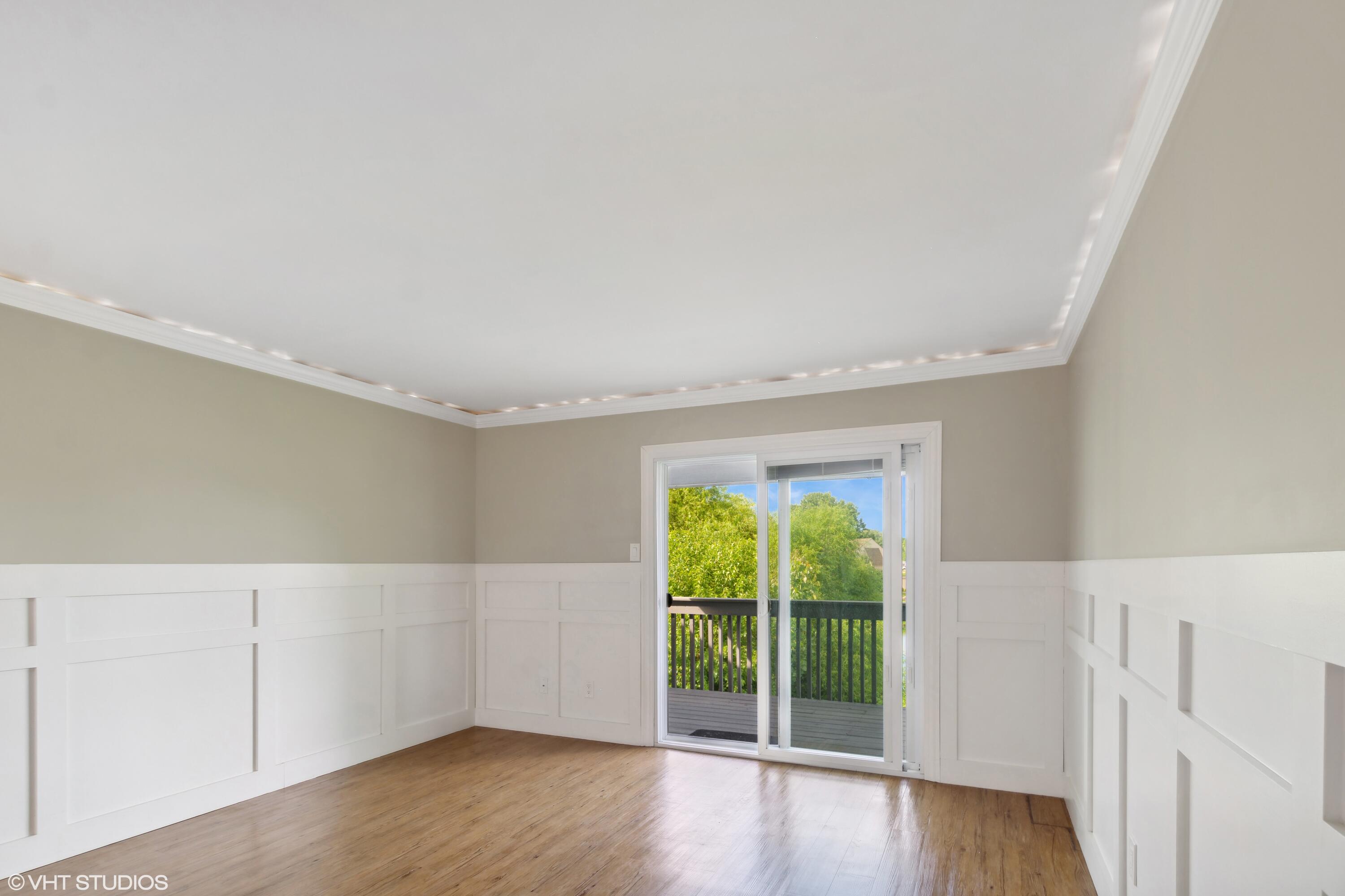 1069 Millpond Road, Unit G Valparaiso, IN 46385 - Photo 4 of 13 a view of an empty room with a window and wooden floor
