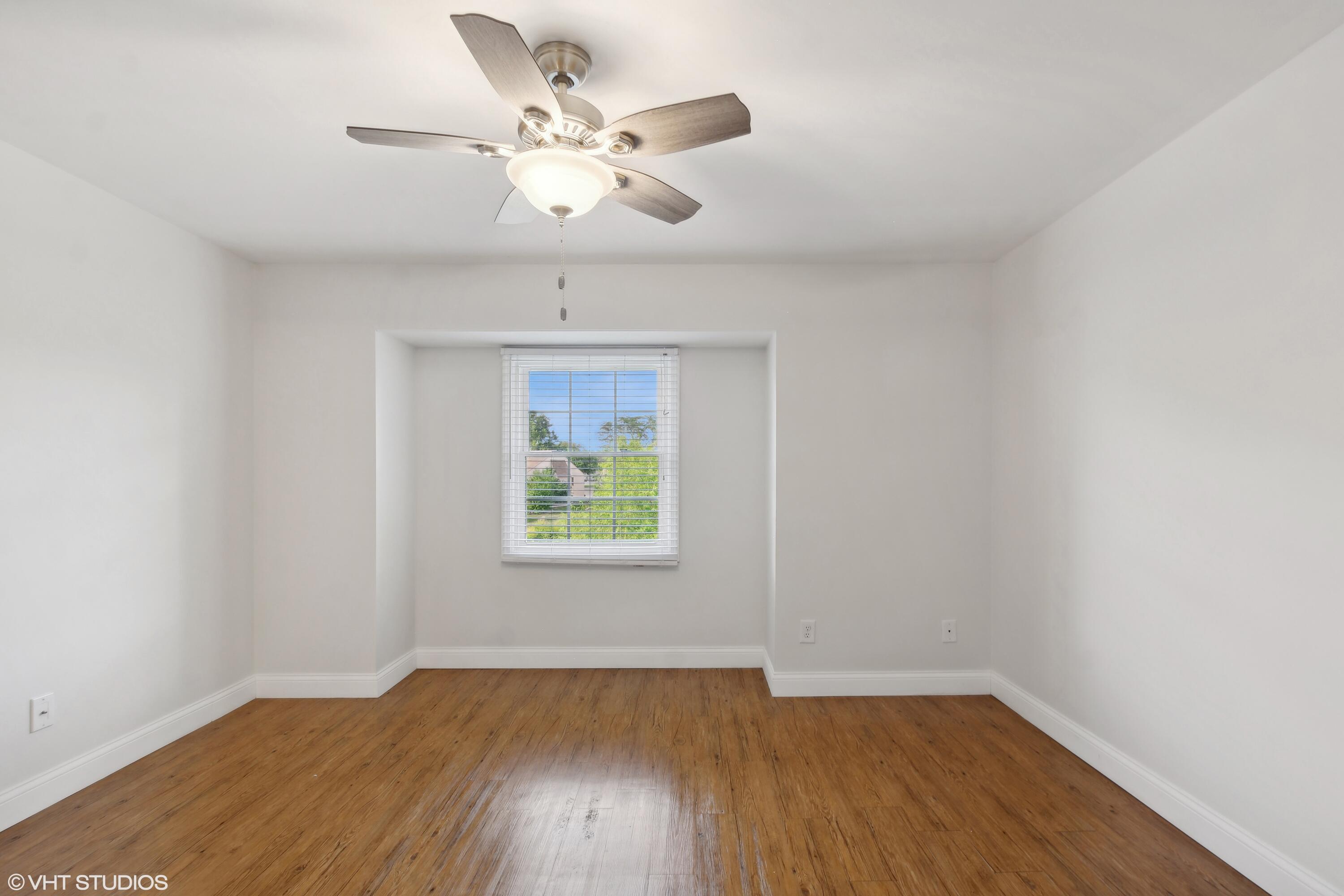 1069 Millpond Road, Unit G Valparaiso, IN 46385 - Photo 5 of 13 an empty room with wooden floor and windows
