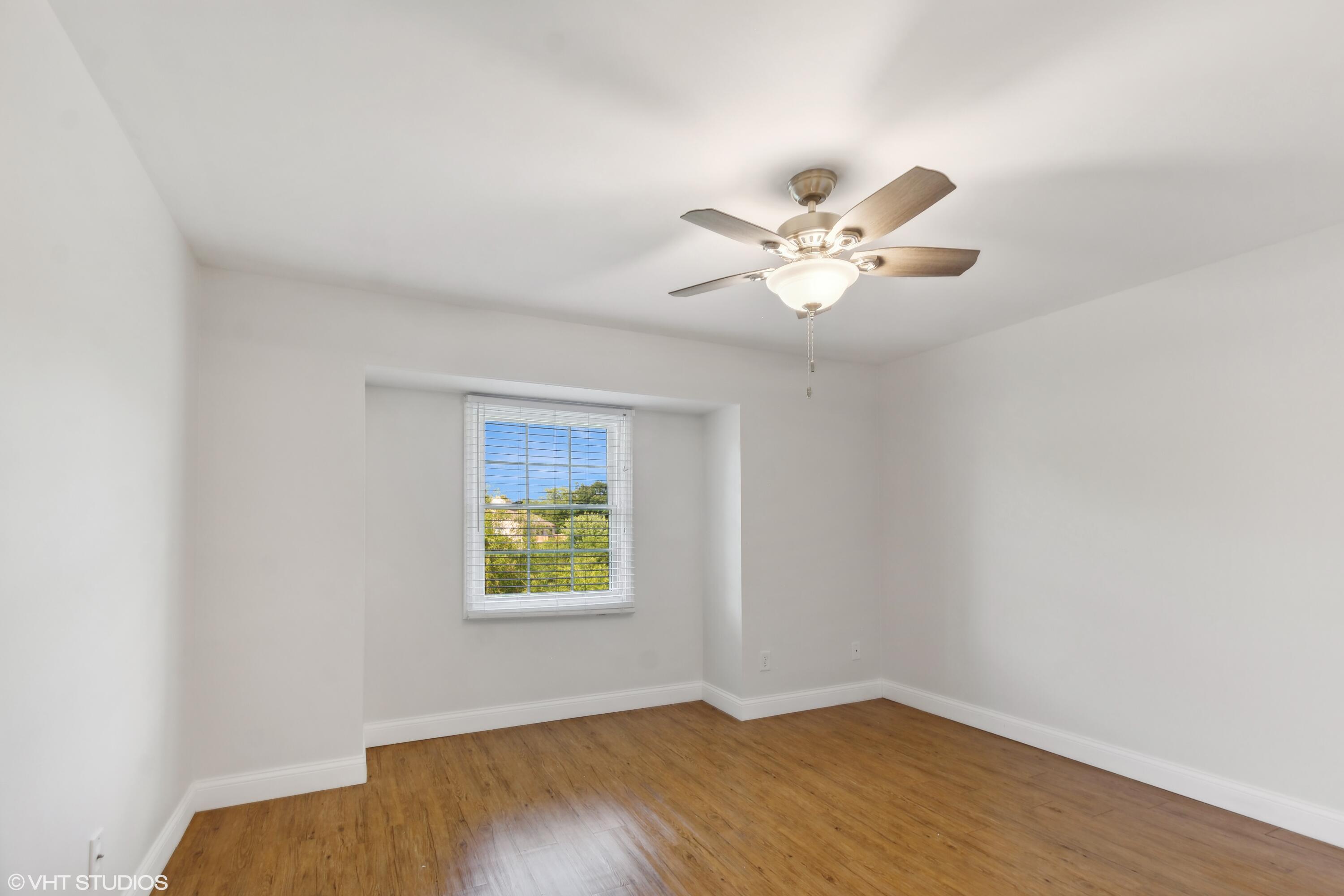 1069 Millpond Road, Unit G Valparaiso, IN 46385 - Photo 6 of 13 an empty room with windows and ceiling fan