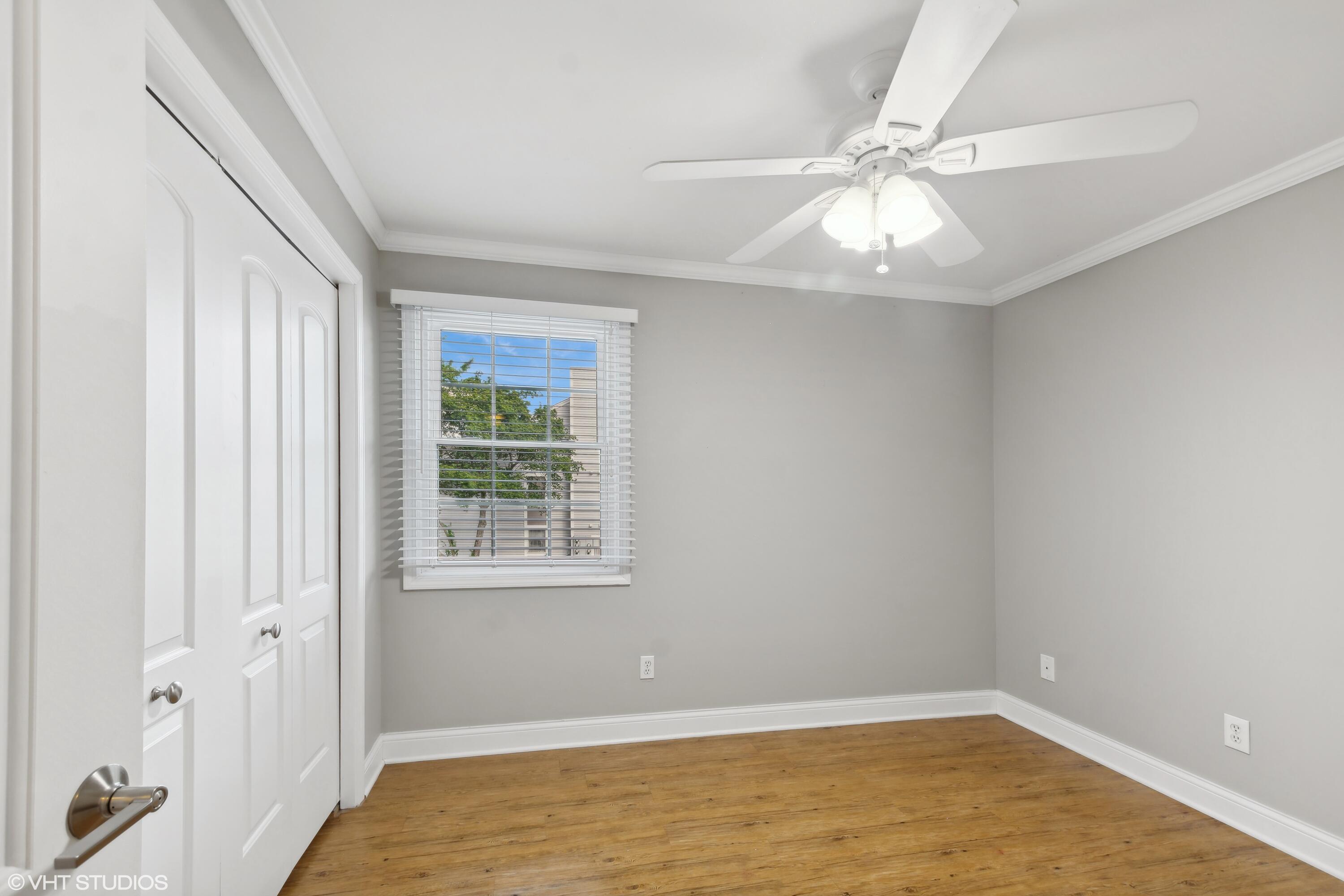 1069 Millpond Road, Unit G Valparaiso, IN 46385 - Photo 7 of 13 a view of an empty room with wooden floor and a window