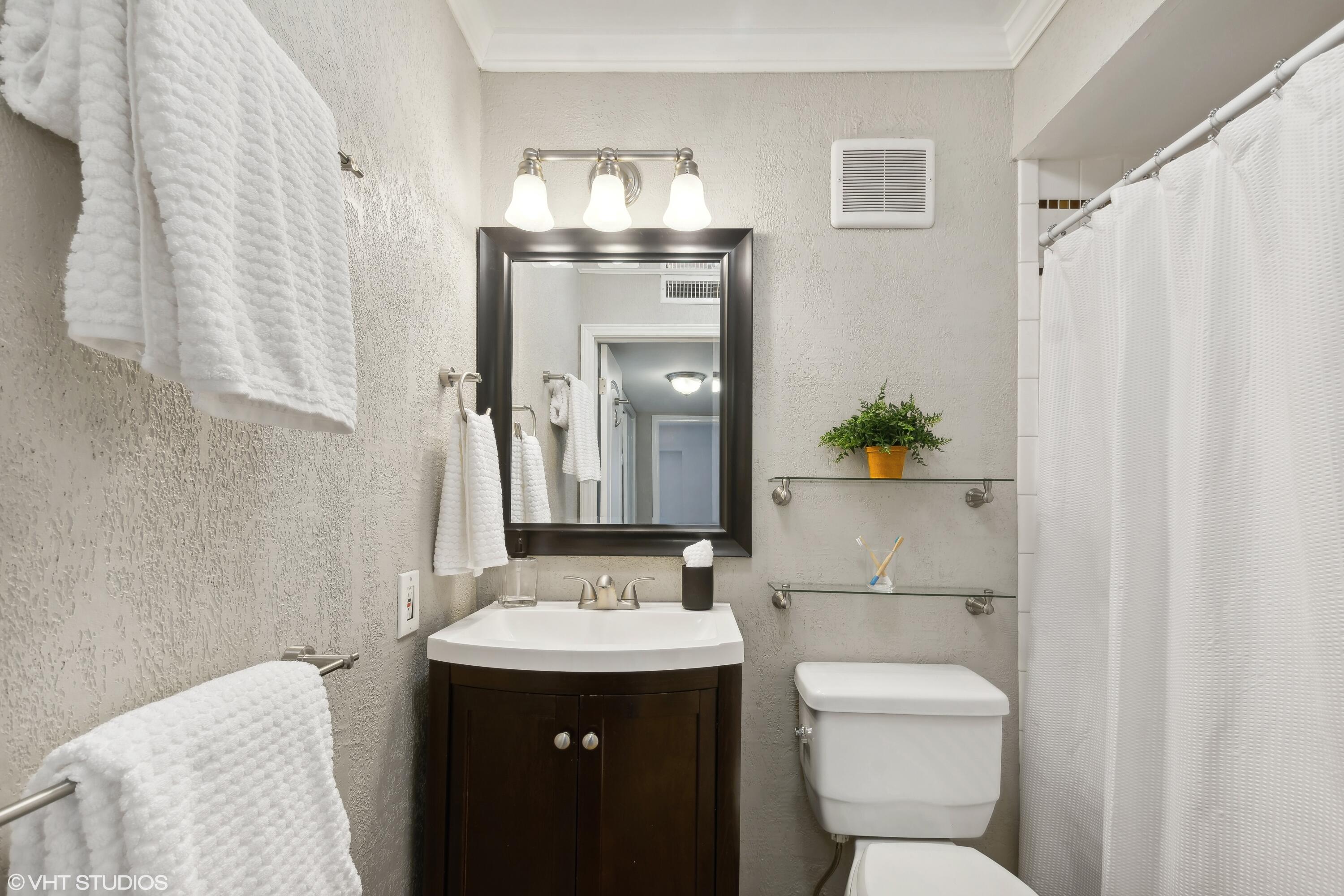 1069 Millpond Road, Unit G Valparaiso, IN 46385 - Photo 9 of 13 a bathroom with a sink toilet and mirror