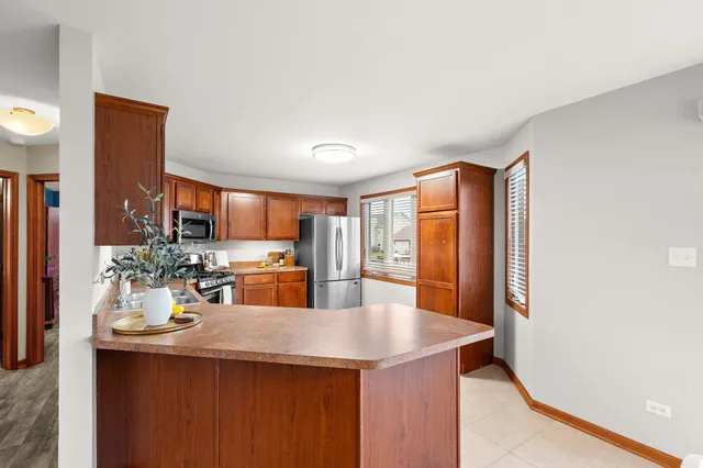 a kitchen with refrigerator and cabinets