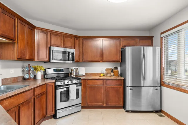 a kitchen with sink a microwave and cabinets
